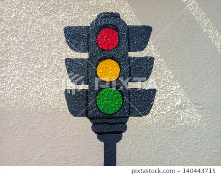 Hand-painted traffic light icon signals on a textured white stucco wall. Hand-painted traffic light icon signals on a textured white stucco wall. 140443715