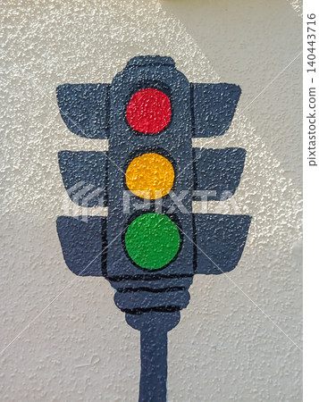 Hand-painted traffic light icon signals on a textured white stucco wall. Hand-painted traffic light icon signals on a textured white stucco wall. 140443716