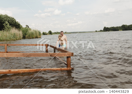dynamic, relaxed shot boy jumping into natural lake. child is captured mid flight, creating sense excitement. image perfect family vacations, water safety, promoting active lifestyle among children dynamic, relaxed shot boy jumping into natural lake. child is captured mid flight, creating sense excitement. image perfect family vacations, water safety, promoting active lifestyle among children 140443829