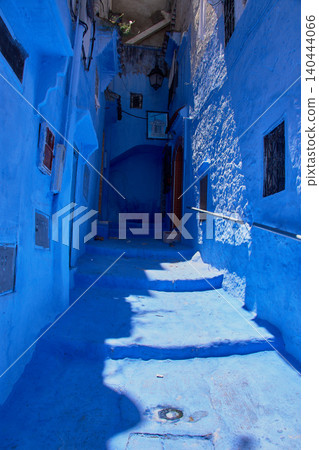 A narrow pedestrian street displays its bright blue painted walls in the medina of Chefchaouen, Morocco A narrow pedestrian street displays its bright blue painted walls in the medina of Chefchaouen, Morocco 140444066