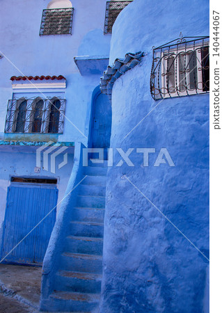 A narrow pedestrian street displays its bright blue painted walls in the medina of Chefchaouen, Morocco A narrow pedestrian street displays its bright blue painted walls in the medina of Chefchaouen, Morocco 140444067