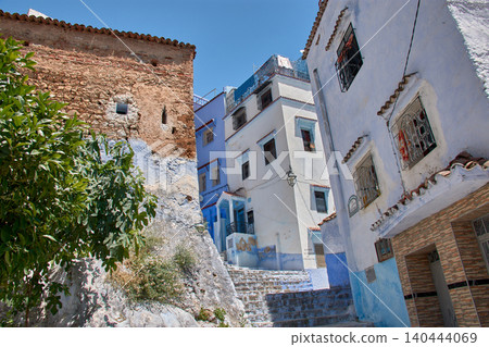 A narrow pedestrian street displays its bright blue painted walls in the medina of Chefchaouen, Morocco A narrow pedestrian street displays its bright blue painted walls in the medina of Chefchaouen, Morocco 140444069