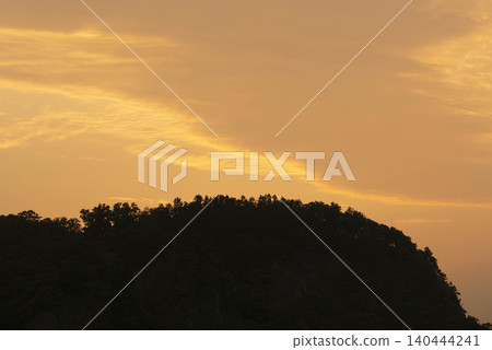 The silhouette of a forest floating in the sunset sky, a silent scene before dawn. The silhouette of a forest floating in the sunset sky, a silent scene before dawn. 140444241