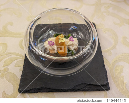 Appetizer served on a glass plate with sea urchin Appetizer served on a glass plate with sea urchin 140444545