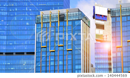 Crane on the construction site in a site surrounded by the high buildings. Office building under construction in the vicinity of high apartment buildings and office building. Crane on the construction site in a site surrounded by the high buildings. Office building under construction in the vicinity of high apartment buildings and office building. 140444569