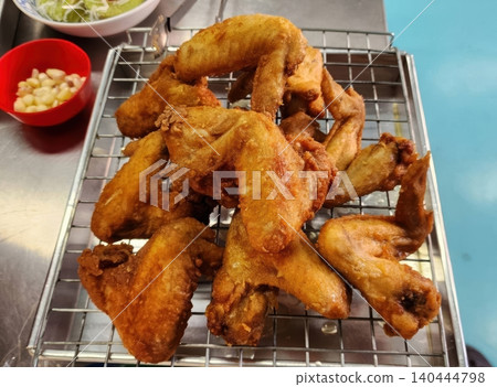 Golden Crispy Deep Fried Chicken Wings on a Cooling Rack Street Food Golden Crispy Deep Fried Chicken Wings on a Cooling Rack Street Food 140444798