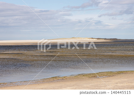 Flat beach and sand dune landscape at low tide Flat beach and sand dune landscape at low tide 140445515