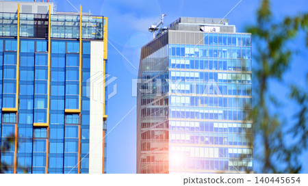 Sustainable glass office building with trees for reducing carbon dioxide. Eco-friendly building in modern city. Office with green environment. Corporate building reduce CO2. Sustainable glass office building with trees for reducing carbon dioxide. Eco-friendly building in modern city. Office with green environment. Corporate building reduce CO2. 140445654