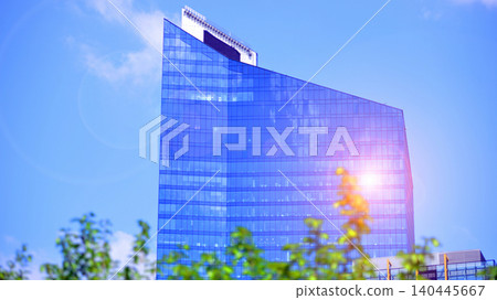 Sustainable glass office building with trees for reducing carbon dioxide. Eco-friendly building in modern city. Office with green environment. Corporate building reduce CO2. 140445667