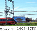 Kintetsu Limited Express "Hinotori" travels past the reconstructed ruins within the Heijo Palace Site, a World Heritage Site. 140445755