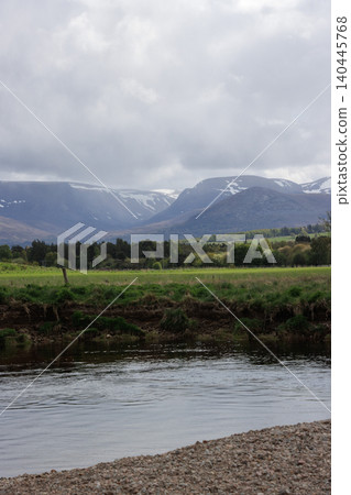 River Spey flowing through valley with Lairig Ghru mountain pass in background, Aviemore, Scotland River Spey flowing through valley with Lairig Ghru mountain pass in background, Aviemore, Scotland 140445768