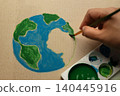 Earth Day painting activist concept with hand painting globe on cardboard, eco creativity 140445916