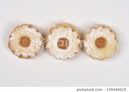 Three Linzer cookies lined up on a white background 140446029