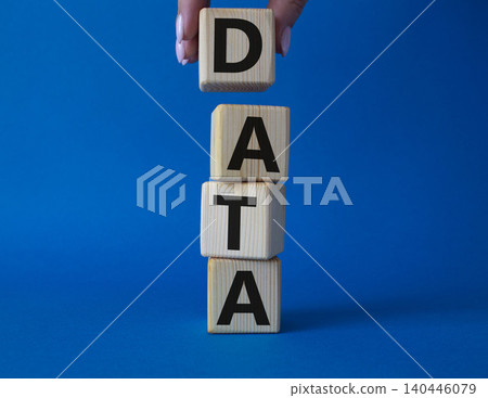 Data symbol. Concept word Data on wooden cubes. Businessman hand. Beautiful blue background. Business and Data concept. Copy space. Data symbol. Concept word Data on wooden cubes. Businessman hand. Beautiful blue background. Business and Data concept. Copy space. 140446079