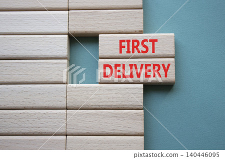 FIRST DELIVERY symbol. Concept word FIRST DELIVERY on wooden blocks. Beautiful grey green background. Business and FIRST DELIVERY concept. Copy space 140446095