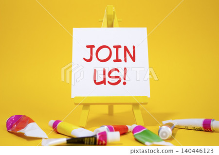 Join us symbol. Concept word Join us on wooden blocks. Beautiful yellow background with paints and easel. Business and Join us concept. Copy space Join us symbol. Concept word Join us on wooden blocks. Beautiful yellow background with paints and easel. Business and Join us concept. Copy space 140446123