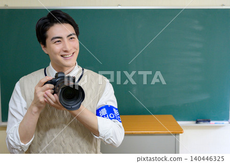 Japanese male photographer with a camera at school Japanese male photographer with a camera at school 140446325