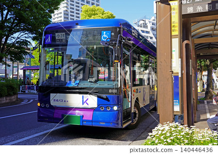 A Keisei Bus Tokyo electric bus (BYD J7) departing from the bus stop in front of Koiwa Station. 140446436