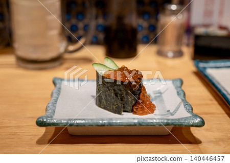 Sushi with salmon roe spilling out 140446457