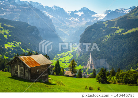 Wooden huts on the alpine slope slope, Lauterbrunnen valley, Switzerland Wooden huts on the alpine slope slope, Lauterbrunnen valley, Switzerland 140446785