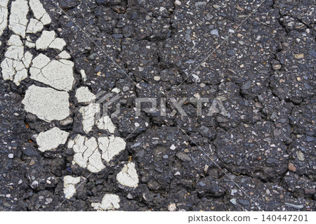 Old Cracked Asphalt with Shattered Road Marking Texture Background Old Cracked Asphalt with Shattered Road Marking Texture Background 140447201
