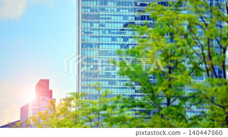 Modern office building with glass facade on a clear sky background. Transparent glass wall of office building. 140447860