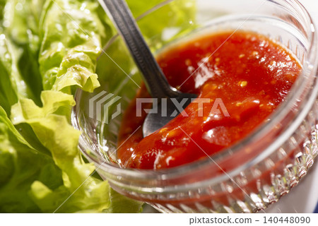 A scene of preparing a salad made with fresh lettuce and tomato dressing. A scene of preparing a salad made with fresh lettuce and tomato dressing. 140448090