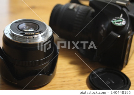 A single-lens reflex camera placed on a desk A single-lens reflex camera placed on a desk 140448195