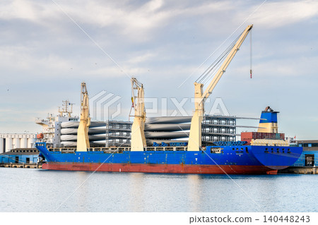 Heavy lift cargo vessel unloading wind turbine blades at Port Adelaide, South Australia Heavy lift cargo vessel unloading wind turbine blades at Port Adelaide, South Australia 140448243