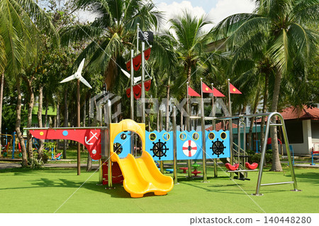 Climbing structures and slides are playground equipment for children, which are part of the public park. 140448280