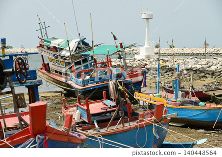 Fishing boats are anchored at the mouth of the river, near Ban Amphoe beach. Thailand. 140448564