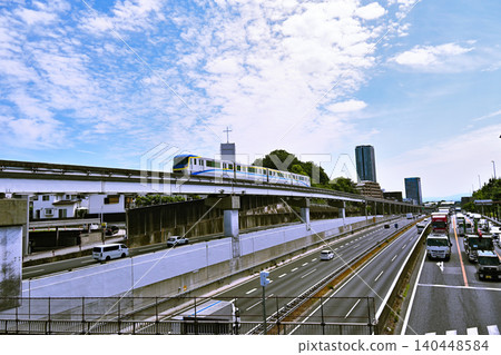 A monorail speeding along under a blue sky. 140448584