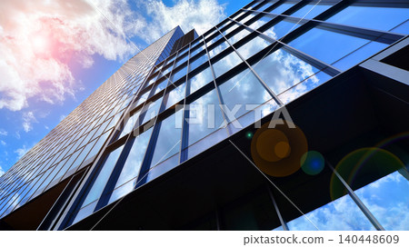View of modern office building with many windows against clear sky. Glass facade wall. View of modern office building with many windows against clear sky. Glass facade wall. 140448609
