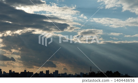 Crepuscular rays shining through gaps in the clouds Crepuscular rays shining through gaps in the clouds 140448656