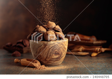 Chocolate truffles in wooden dish are sprinkled with cocoa powder. Chocolate truffles in wooden dish are sprinkled with cocoa powder. 140448705