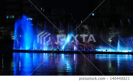 A beautifully lit fountain show along the river. A beautifully lit fountain show along the river. 140448821