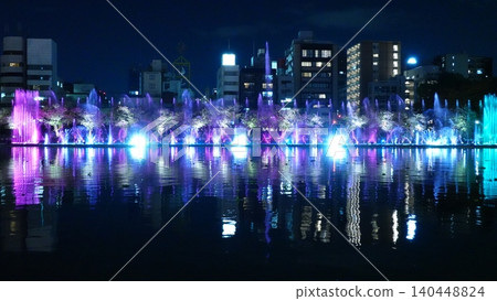 A beautifully lit fountain show along the river. A beautifully lit fountain show along the river. 140448824