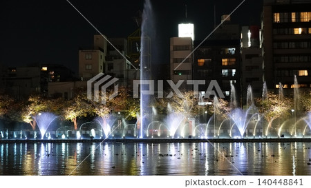 A beautifully lit fountain show along the river. A beautifully lit fountain show along the river. 140448841