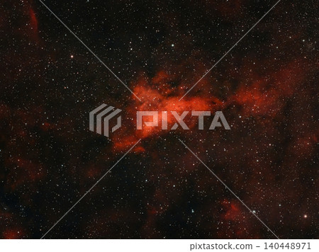 This image shows a red nebula with many stars in the vastness of space. 140448971