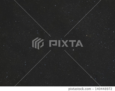 Vast dark night sky is visible, densely packed with myriad white and subtly colored stars. This cosmic view showcases celestial bodies in the depths of space at night. 140448972