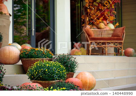 Autumn porch decor with pumpkins and mums creates a festive Thanksgiving scene Autumn porch decor with pumpkins and mums creates a festive Thanksgiving scene 140448990