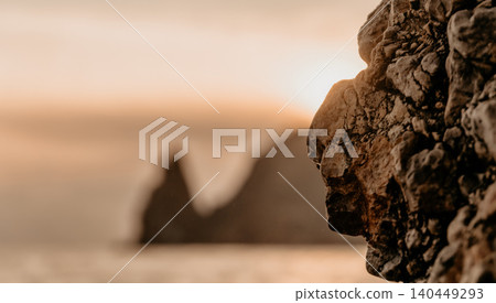 Rock sunset landscape showcasing rugged stone textures with blurred coastal cliffs at sunset for travel and nature themes Rock sunset landscape showcasing rugged stone textures with blurred coastal cliffs at sunset for travel and nature themes 140449293