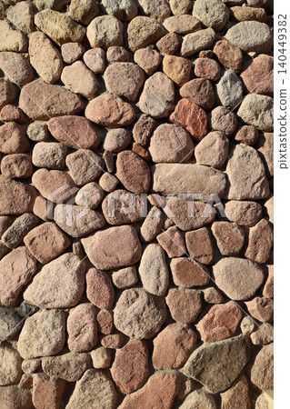 Texture of a wall made of large brown stone Texture of a wall made of large brown stone 140449382