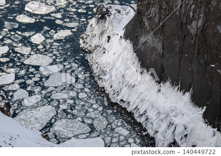 Drift ice and frozen cliffs below Shiretoko Frepe Falls 140449722