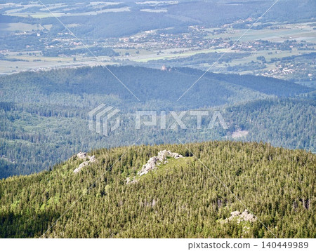 Aerial view of forested mountain ridge with distant valley Aerial view of forested mountain ridge with distant valley 140449989