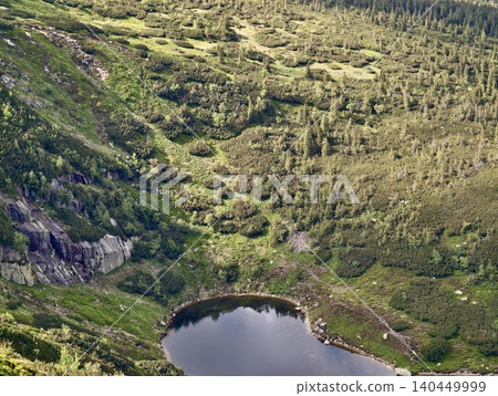 Mountain cirque with small alpine tarn and green shrub slopes Mountain cirque with small alpine tarn and green shrub slopes 140449999