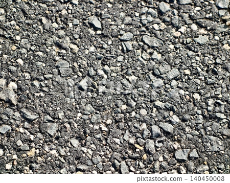 Close-up texture of coarse asphalt with scattered gravel Close-up texture of coarse asphalt with scattered gravel 140450008