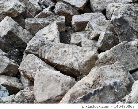 Pile of irregular limestone rocks on natural ground 140450062