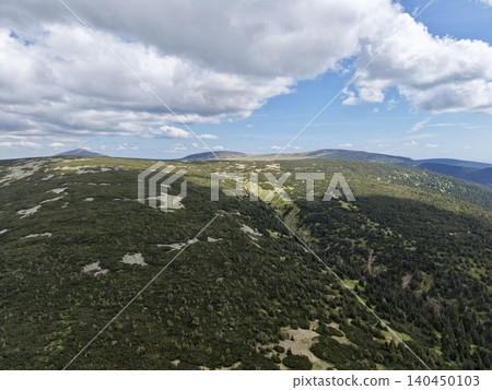 Rolling green mountain ridge under partly cloudy sky Rolling green mountain ridge under partly cloudy sky 140450103