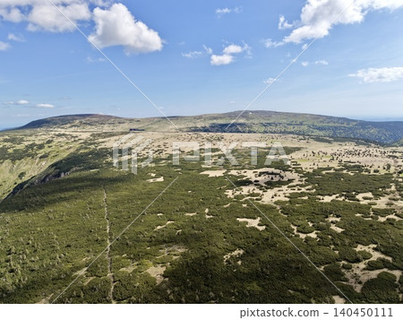 Open mountain plateau with scattered shrubs under blue sky Open mountain plateau with scattered shrubs under blue sky 140450111